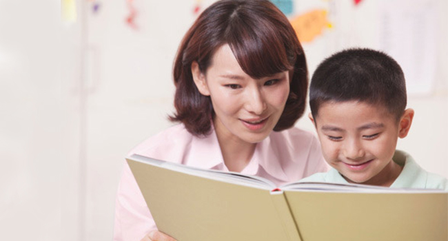 Mother teaching son to read
