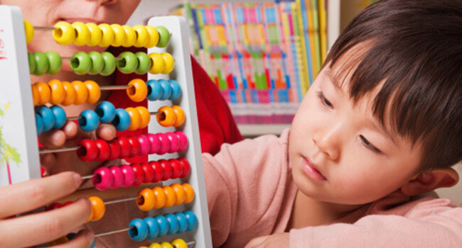 Child Learning Maths with an Abacus